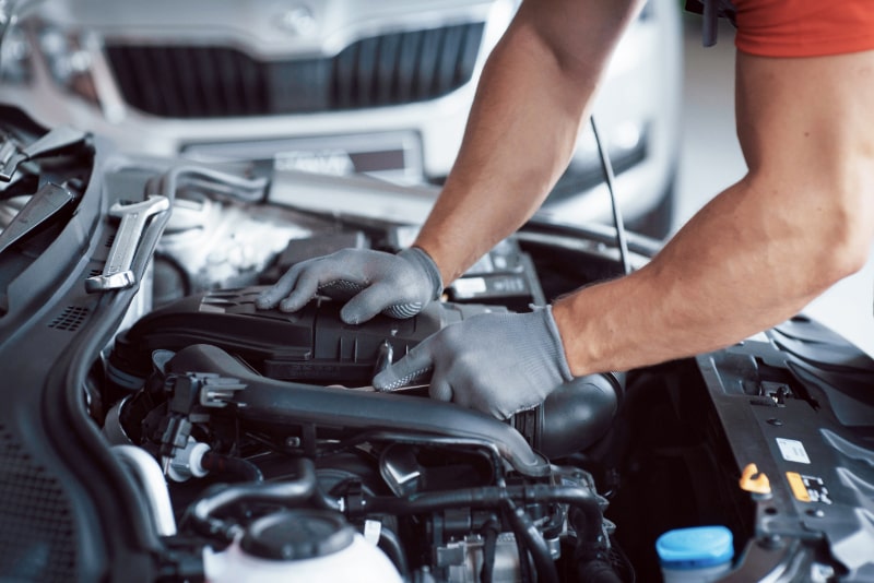 Mechanic Fixing Car Engine